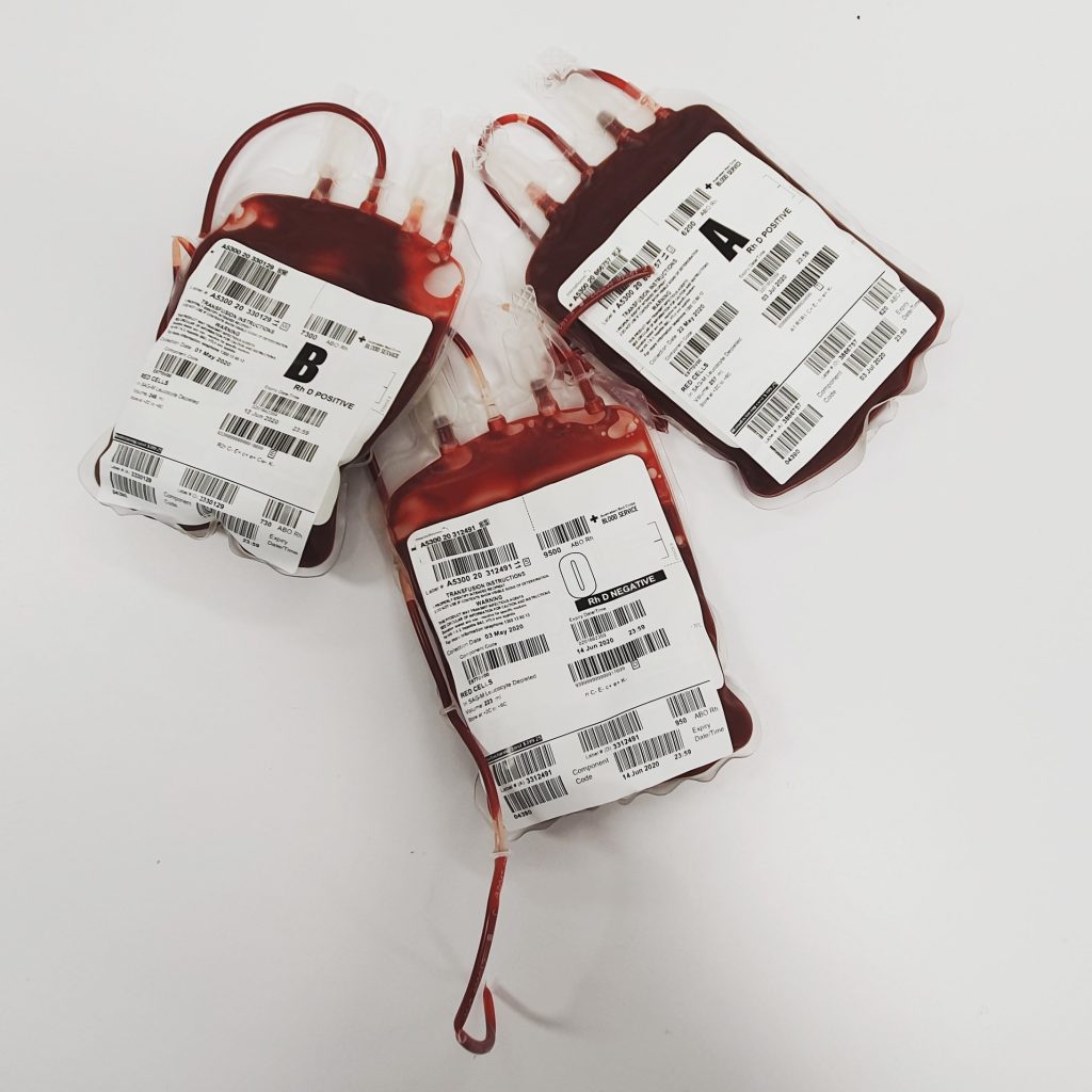 Three packets of donated blood labeled A Positive, B Positive, and O Negative.