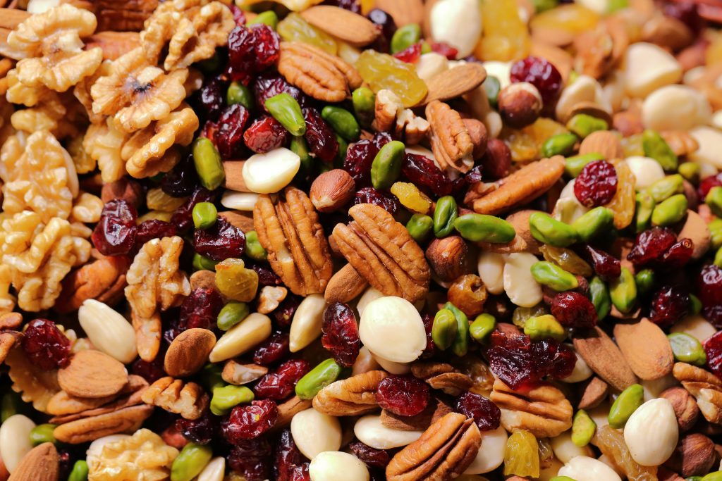 An assorted heap of healthy nuts, including almonds and walnuts, that can satisfy hunger and promote heart health.