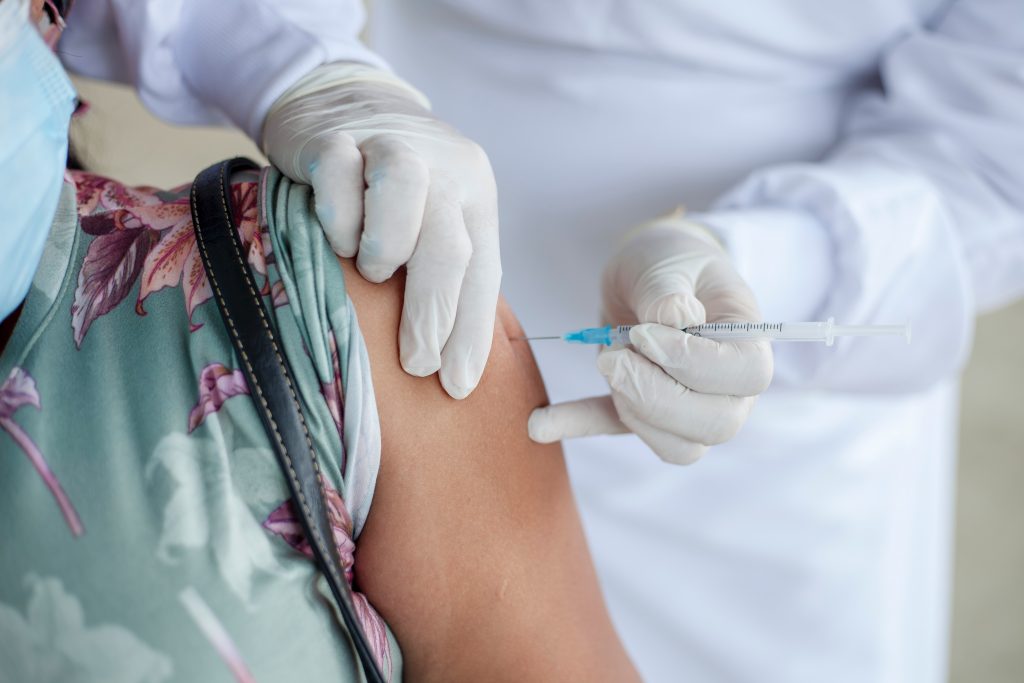 A close-up shot of a person receiving a vaccination.