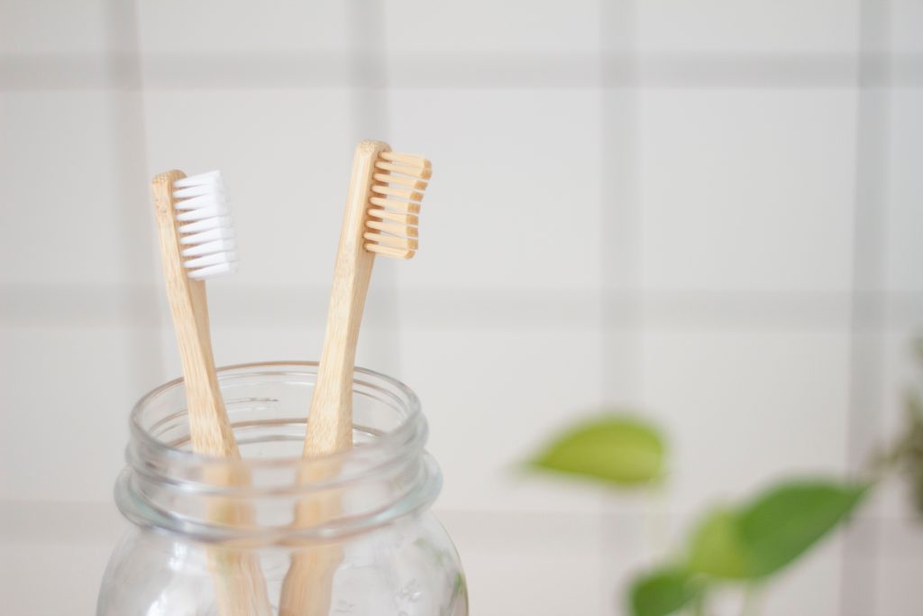 A picture showing two toothbrushes in a jar, emphasizing the importance of not sharing personal hygiene items.