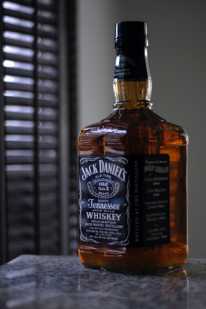 A fully filled alcohol bottle, emphasizing how alcohol consumption can lead to increased blood triglyceride levels.