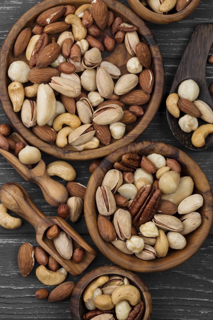 Bowls filled with assorted nuts, highlighting their role in lowering blood triglycerides