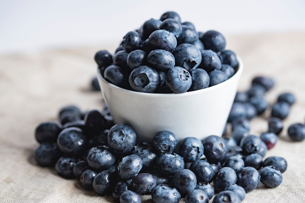 Blueberries, rich in brain-boosting antioxidants, filled in a white bowl.