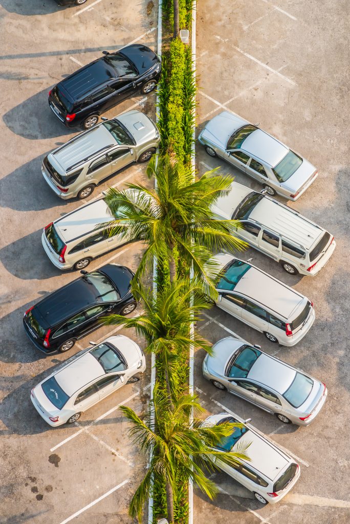 A top view of a car park with cars neatly arranged in their spaces.