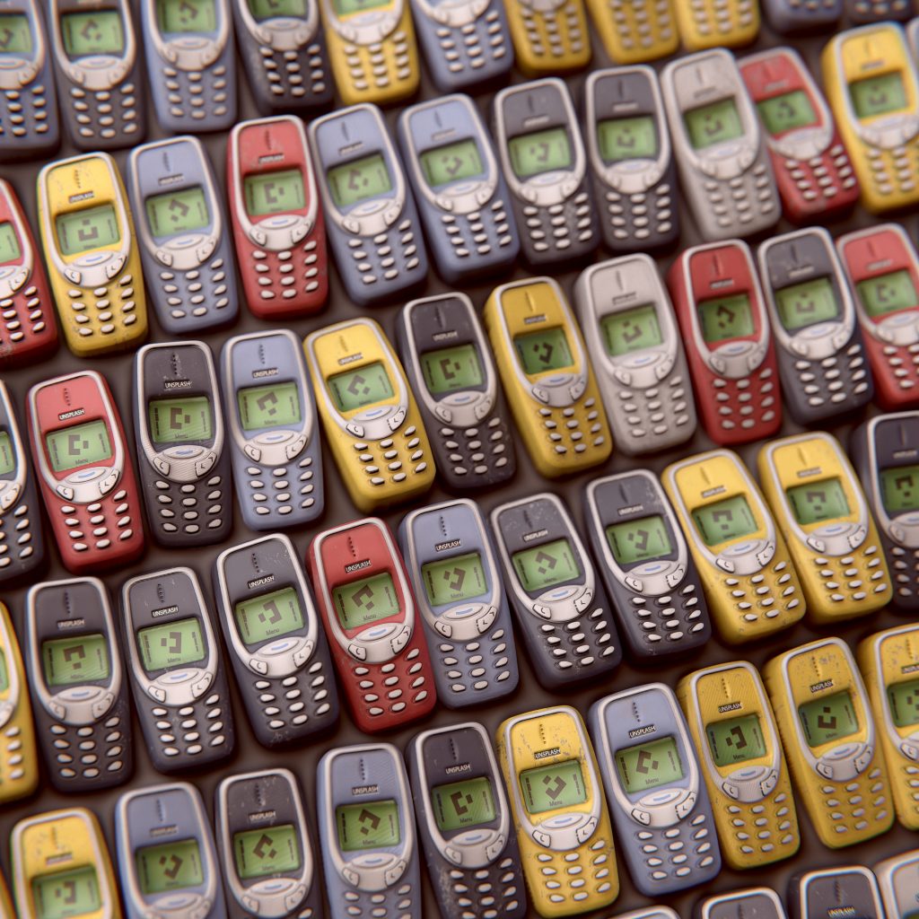 A top-view shot of multiple button phones arranged horizontally in multiple rows.