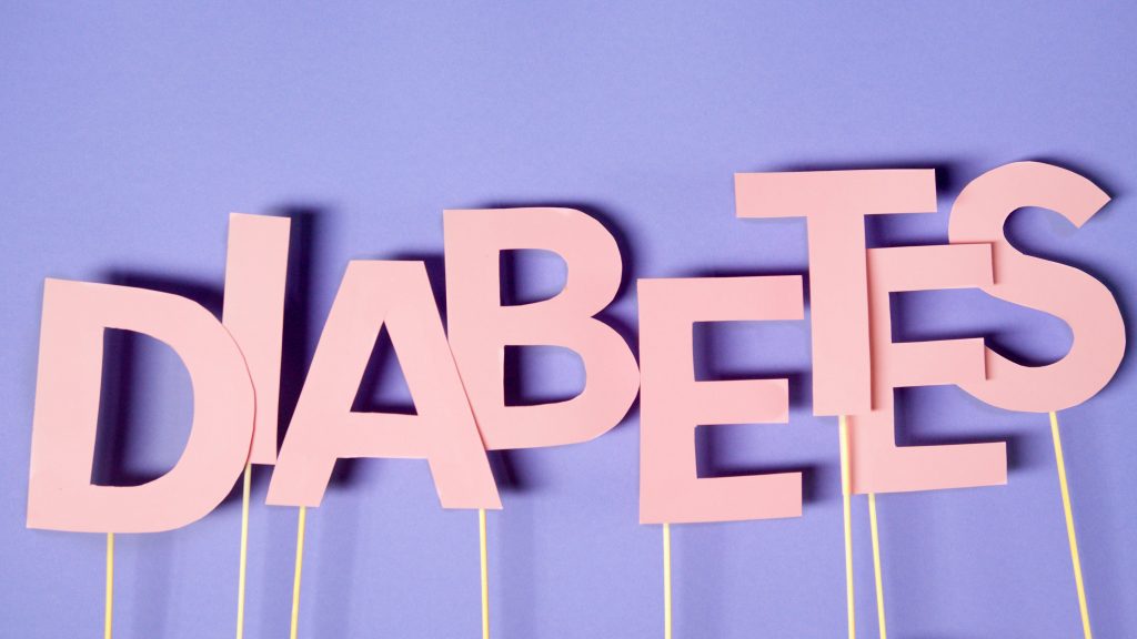 Alphabet flash cards arranged aesthetically to spell "DIABETES," highlighting the importance of awareness.