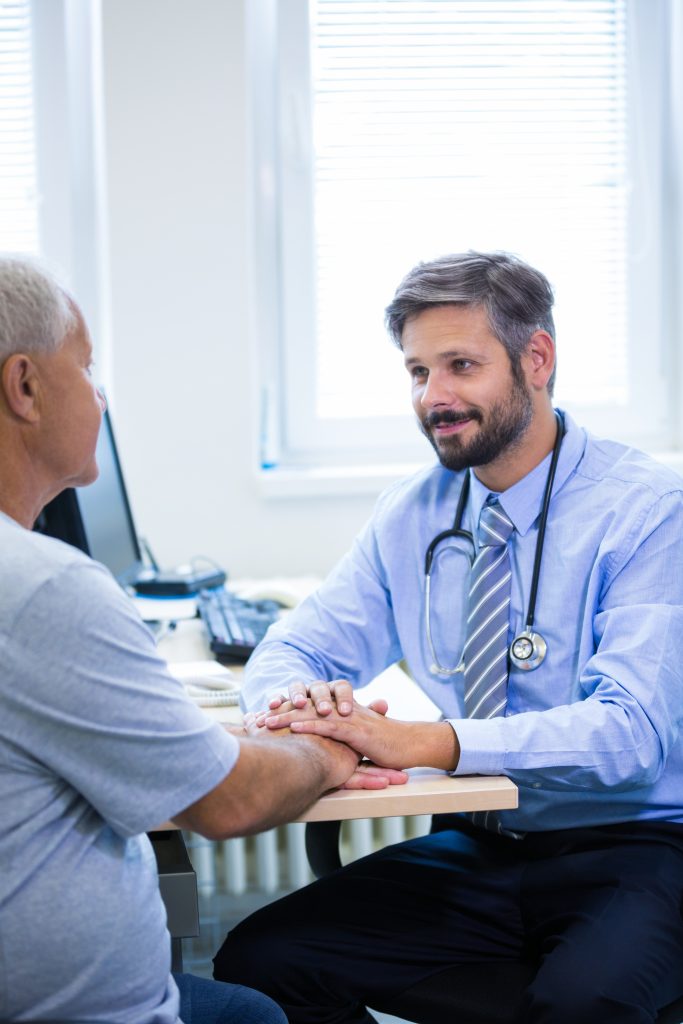A doctor examining an elderly patient.