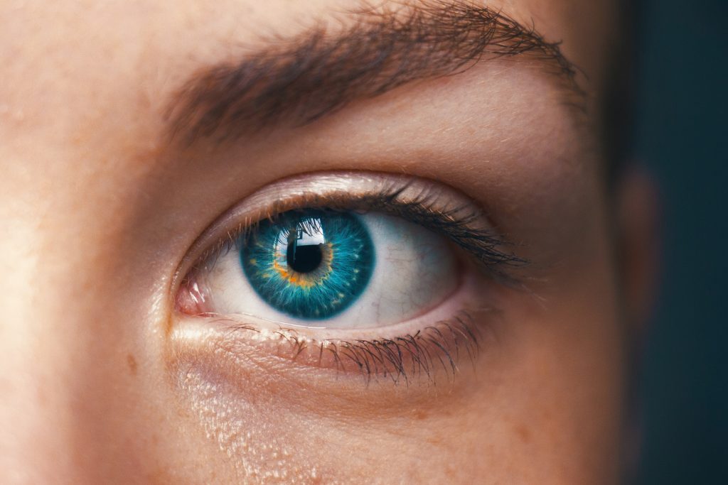 Close-up shot of a bluish-green healthy eye, emphasizing the importance of a well-balanced diet in maintaining eye health.