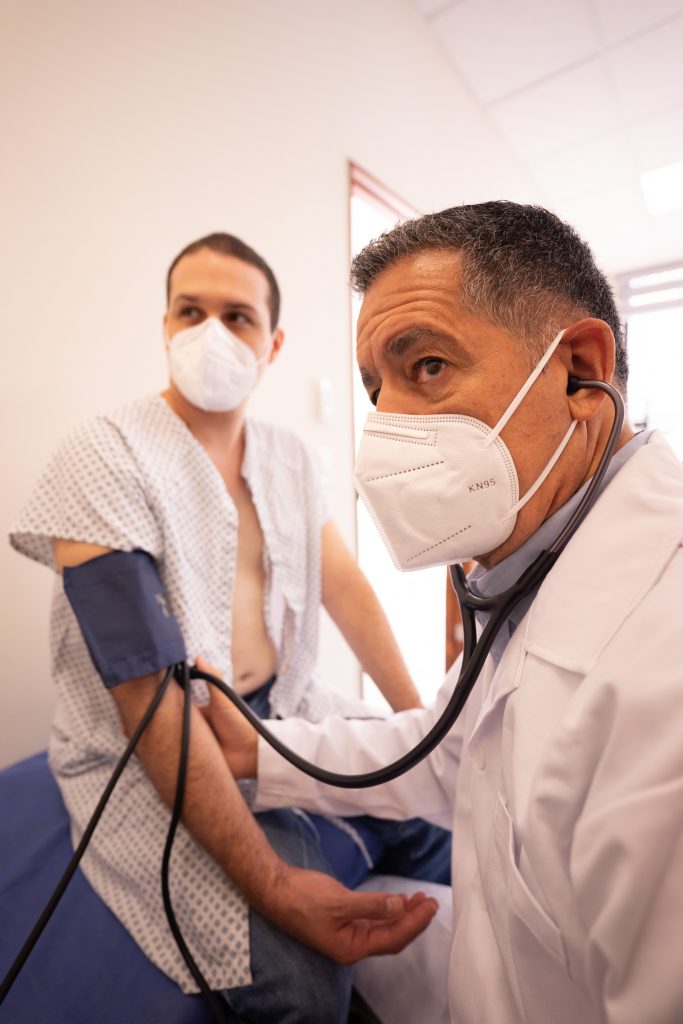 A doctor measuring a patient's blood pressure.