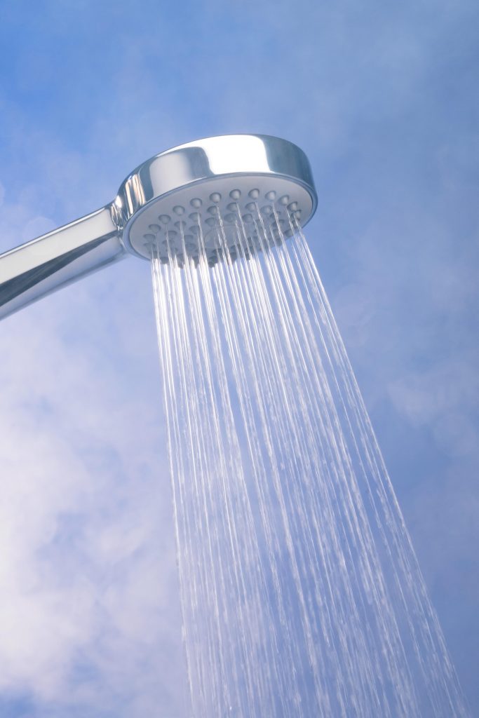 A hot shower, with steam rising, demonstrating how the steam helps individuals suffering from a cold breathe more easily