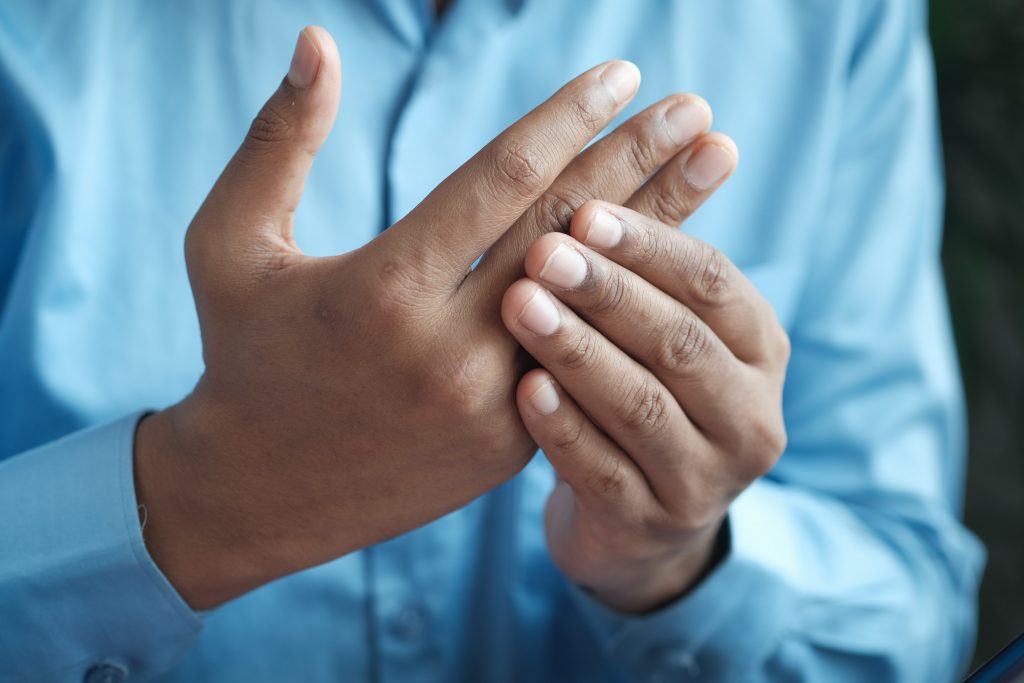 A close-up shot of a man holding his hands together.