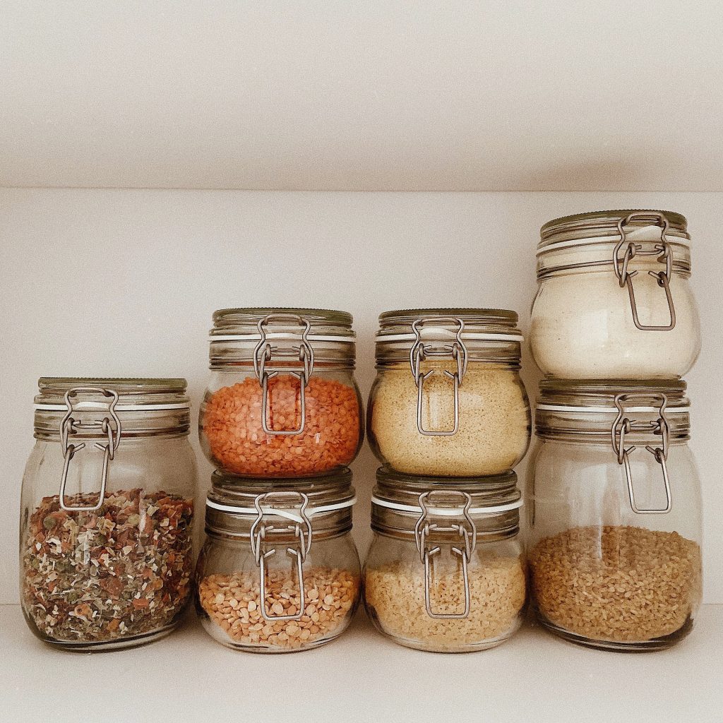 Glass jars filled with lentils, stacked both vertically and horizontally.