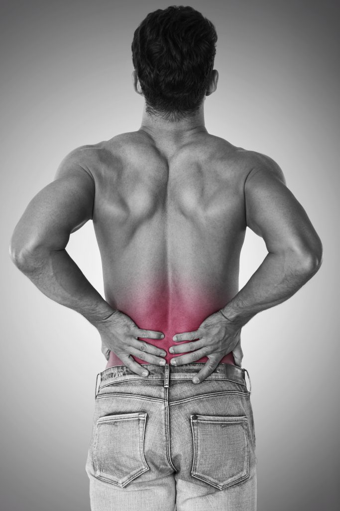 A back shot of a man experiencing severe lower back pain.