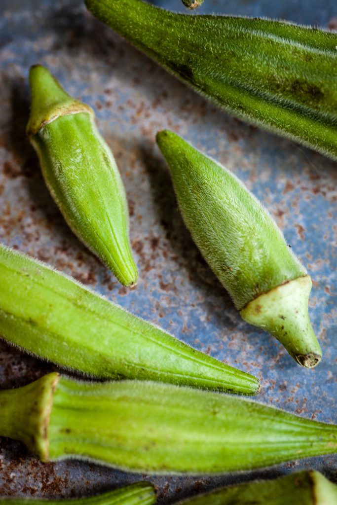 Close-up shot of okra, a rich source of blood-sugar-lowering compounds like polysaccharides and flavonoid antioxidants."
