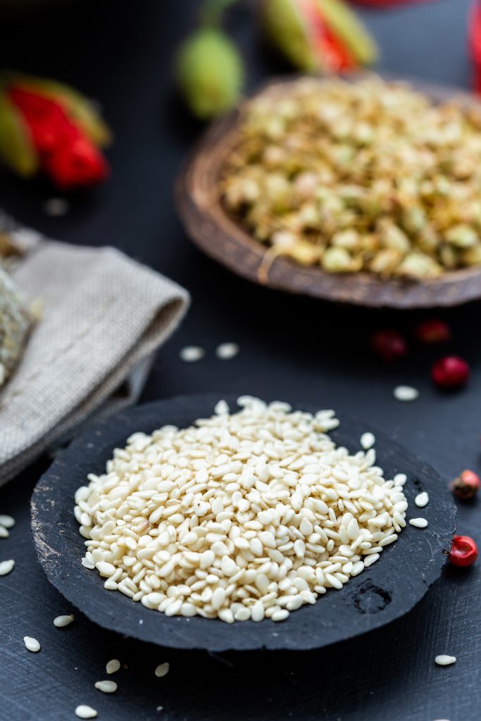 A vertical shot of sesame in a black bowl