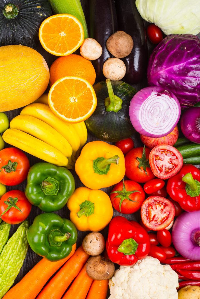 A table full of assorted colorful vegetables, showcasing their importance in lowering cholesterol and promoting heart health.