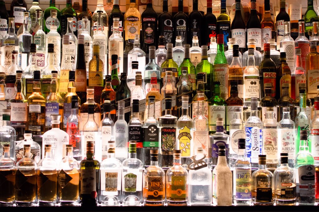 A bar shelf filled with liquor bottles, reminding us that reducing alcohol intake can help lower blood pressure.
