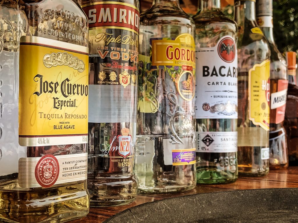A close arrangement of alcohol brands, highlighting the connection to alcohol-related liver disease (ARLD) from overconsumption.
