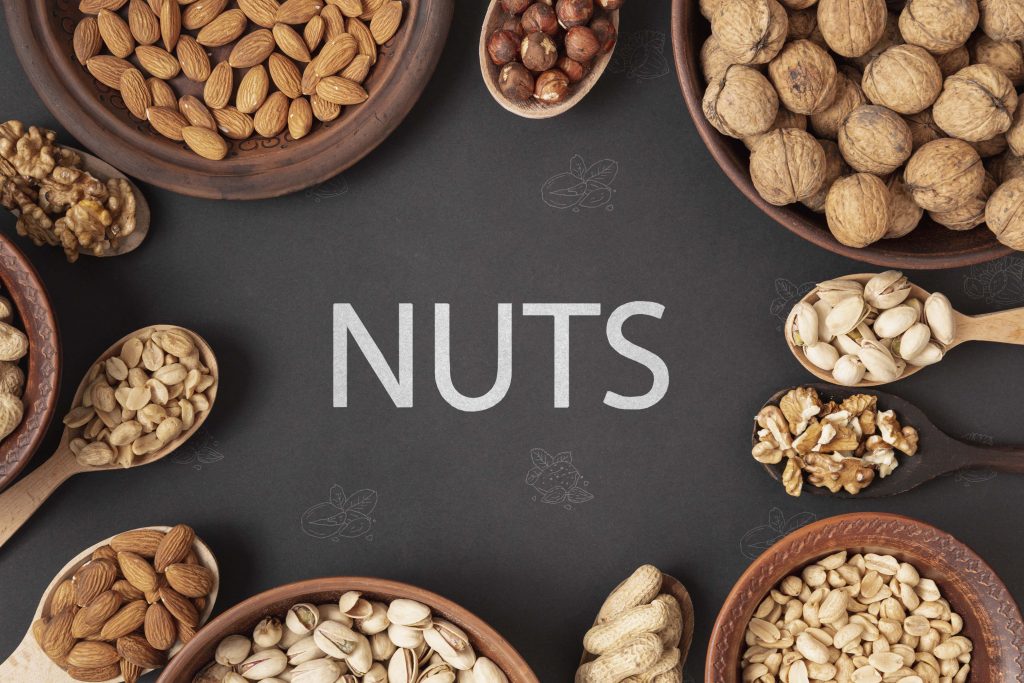 Nuts in wooden bowls with spoons, offering chromium, an essential trace mineral for balanced health.