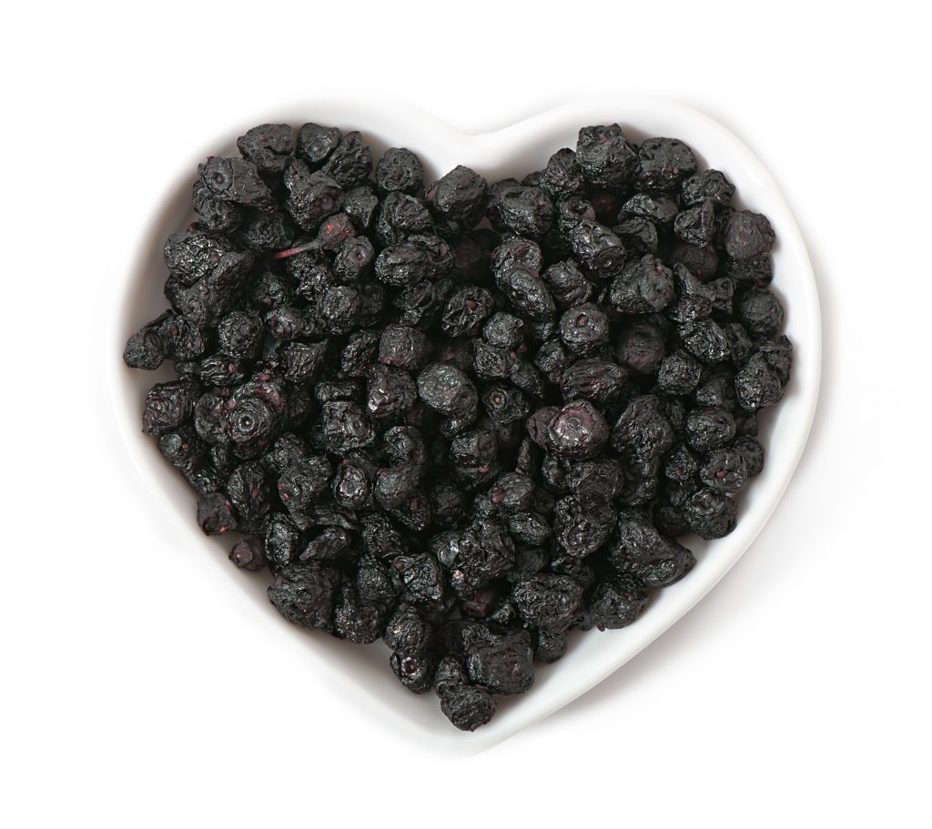 White bowl filled with dark blackberries, a healthy, high-calorie fruit to support weight gain.
