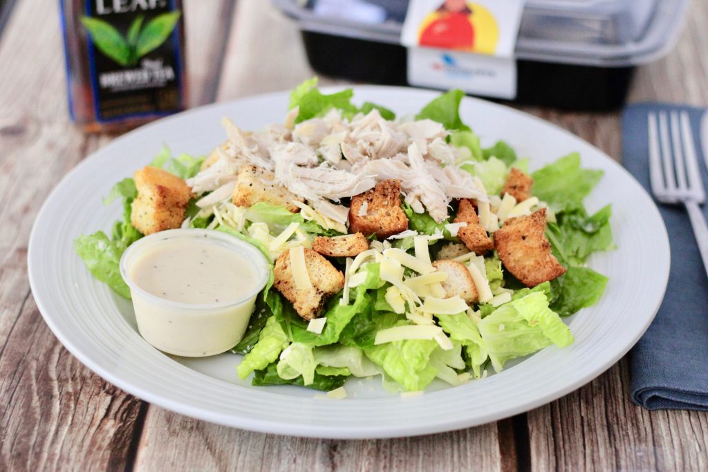 A plate of vegetable salad and chicken, highlighting how a low-carb diet supports better weight loss than a low-fat diet.
