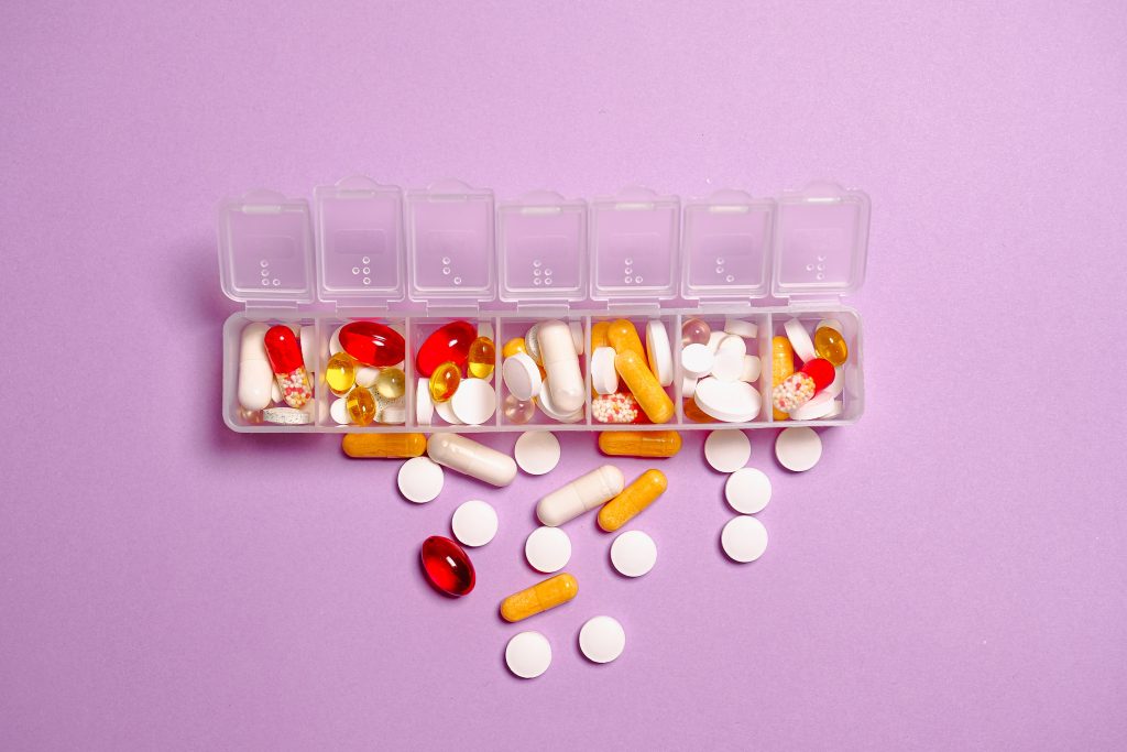 Weekly pill case with medicine, as some health drugs may cause slight weight gain.