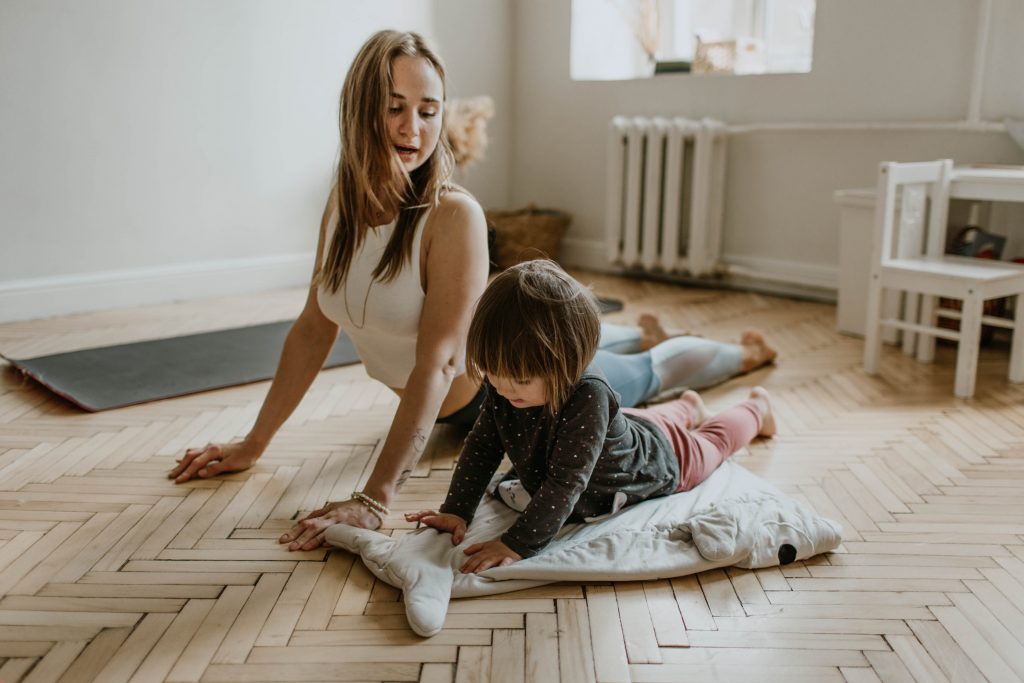Mother and child practicing yoga, demonstrating how moderate exercise can enhance vaccine effectiveness for immune systems.