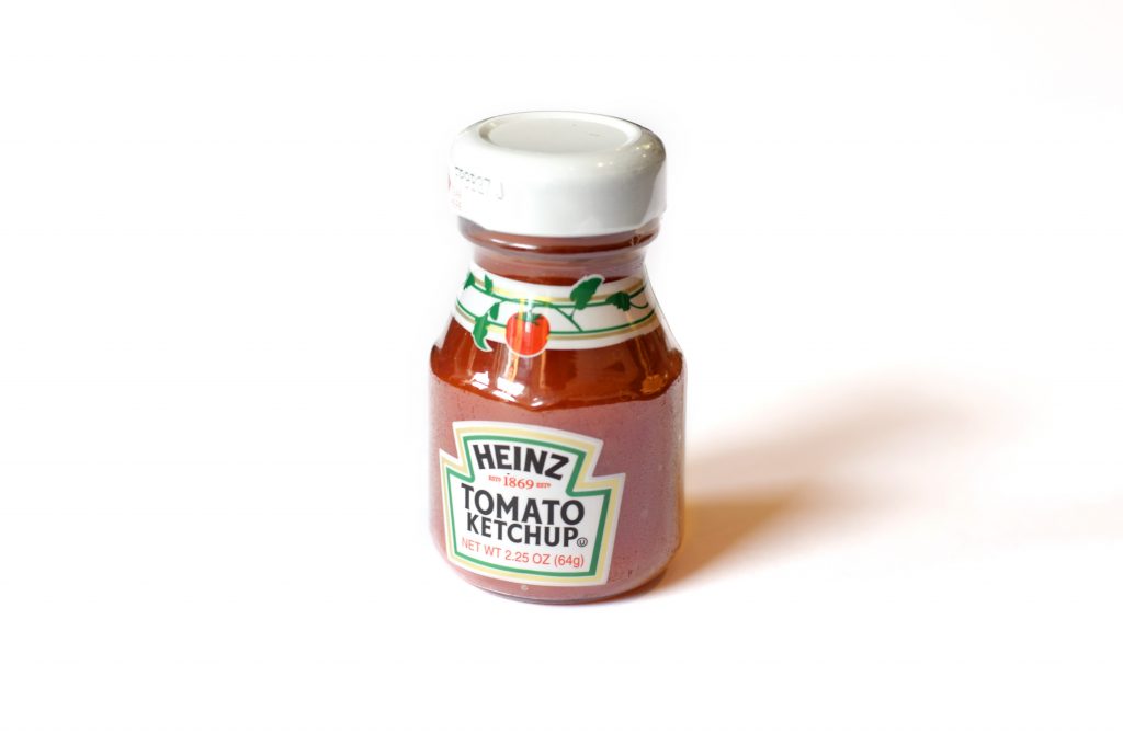 A bottle of Heinz tomato ketchup, highlighting the need to reduce processed foods to help lower blood pressure.