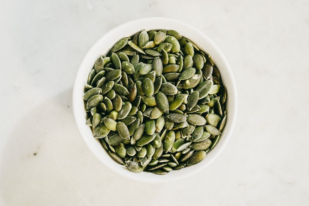 A bowl of pumpkin seeds, helping your body release fat from its stores for energy.