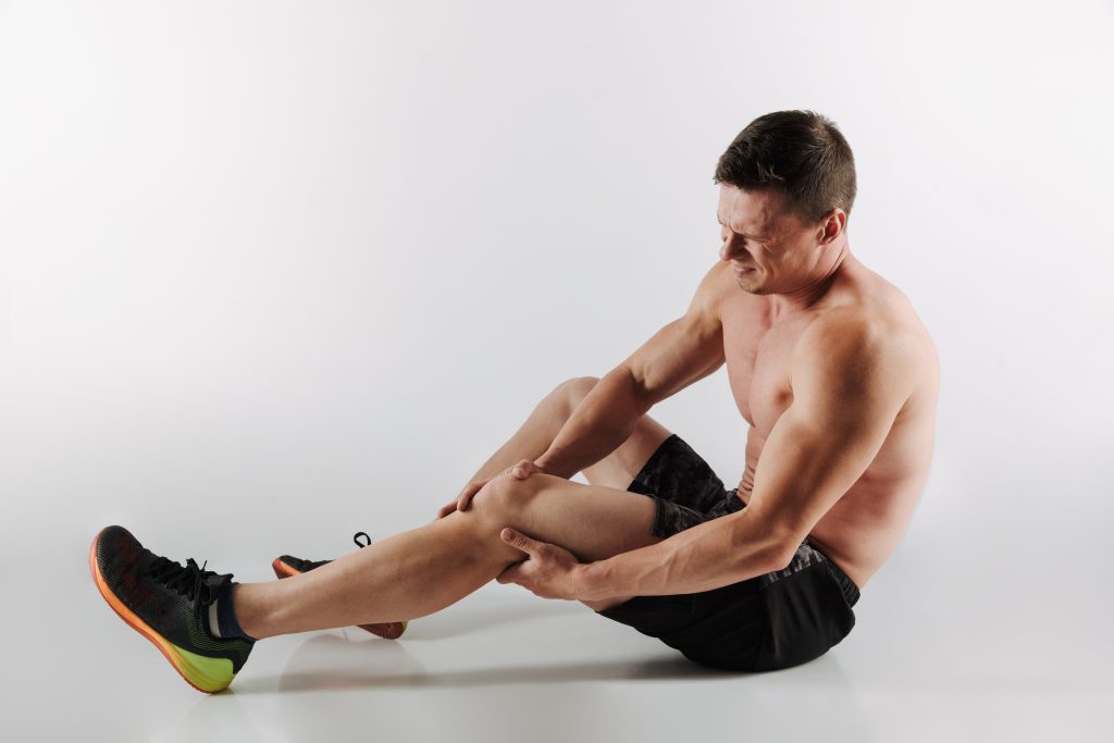 A sportsman stretching, showing how B12 deficiency can cause muscular weakness, tiredness, and lightheadedness.