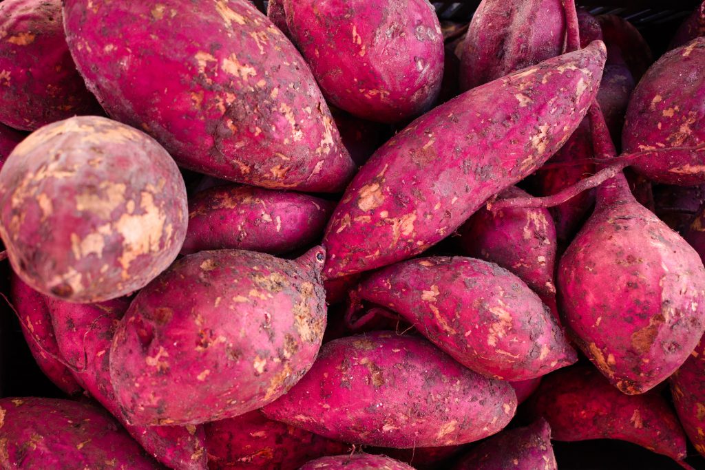 Fresh raw sweet potatoes, a nutrient-packed, fat-fighting food that supports healthy weight management.