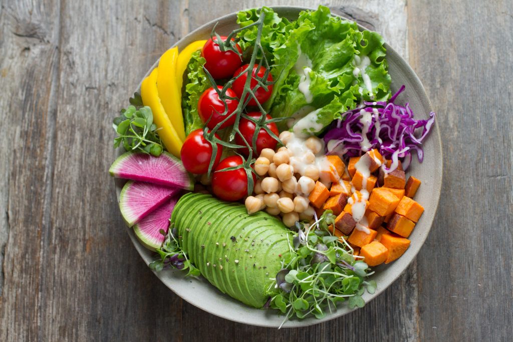 A plate of fresh salad, showing how a strict vegetarian diet, avoiding animal products, can lead to B12 deficiency.