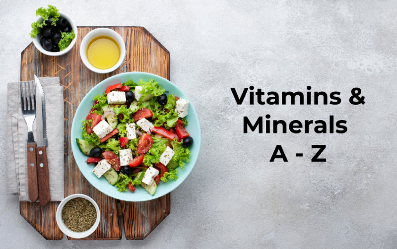 A plate of Salad with cheese, olives, and tomatoes on a wooden board, labeled "Vitamins & Minerals A-Z.