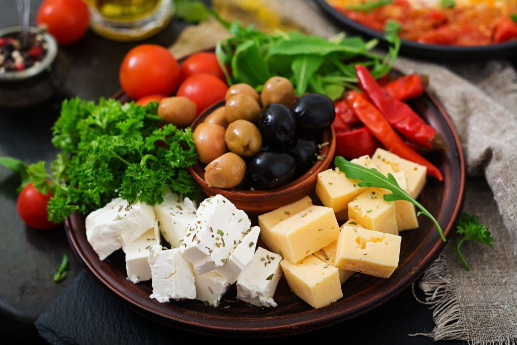 A plate of cheese, paneer, vegetables, and parsley representing the Mediterranean diet's focus on plant-based meals and healthy fats.