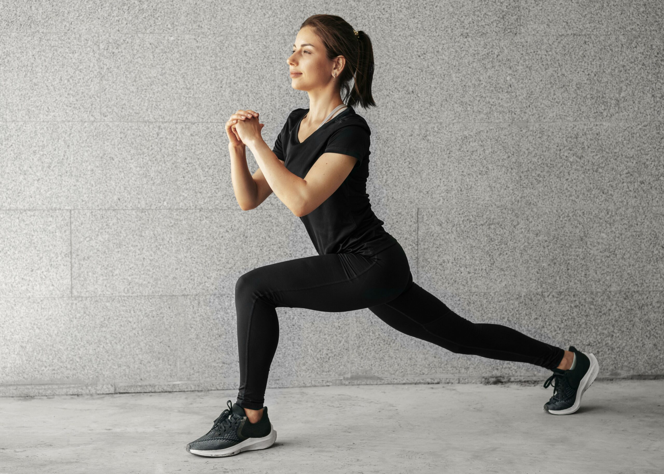 A woman stretching joyfully, illustrating the benefits of exercise for managing hypertension.
