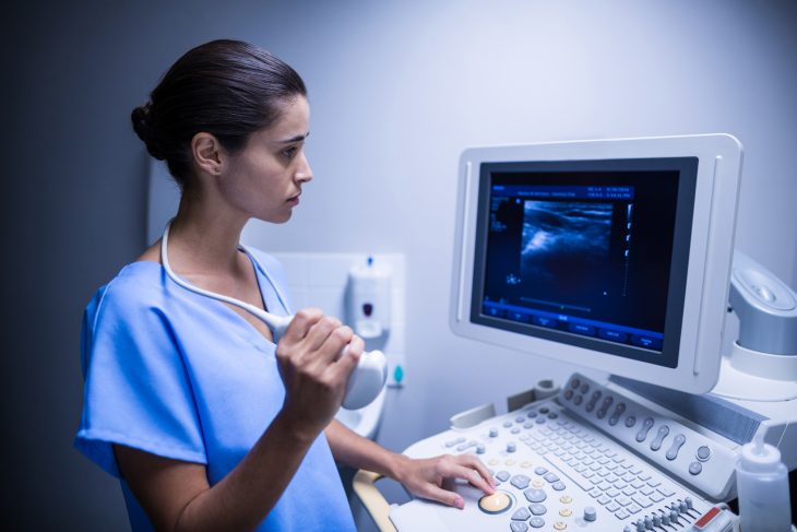 A medical expert examines the ultrasound in a medical clinic. 