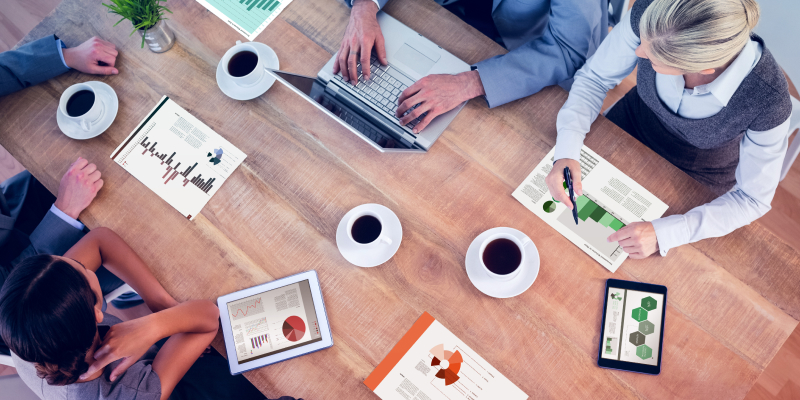 The team discusses graphs showing various employee wellbeing metrics.