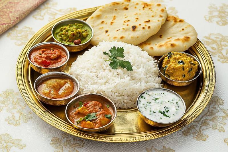 A plate filled with a colourful assortment of home-cooked dishes.