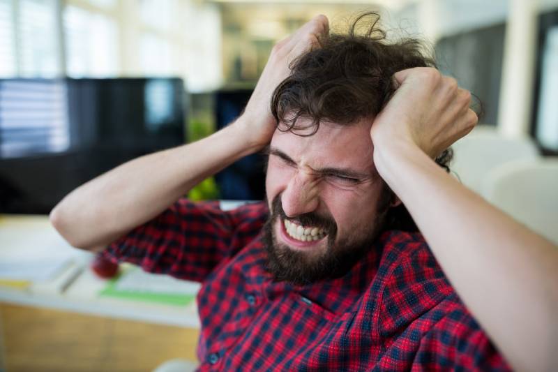 A stressed young man during the smoking cessation treatment.