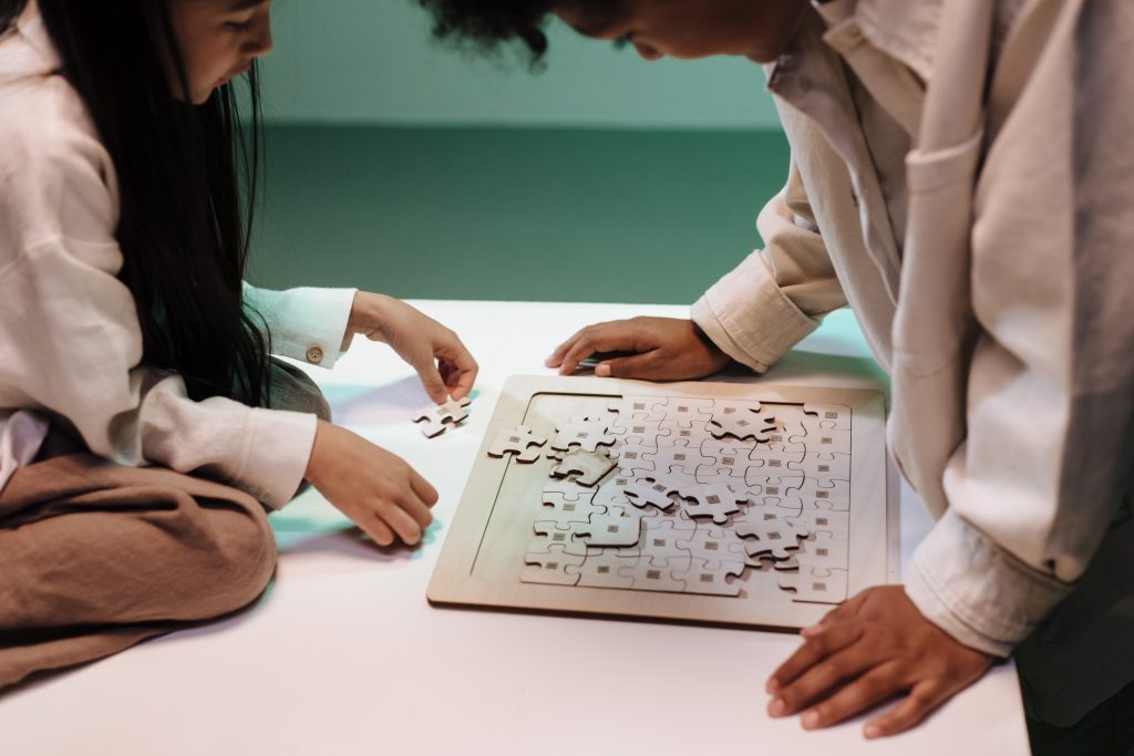 Two kids playing a brain puzzle board game, an effective way to strengthen brain power.