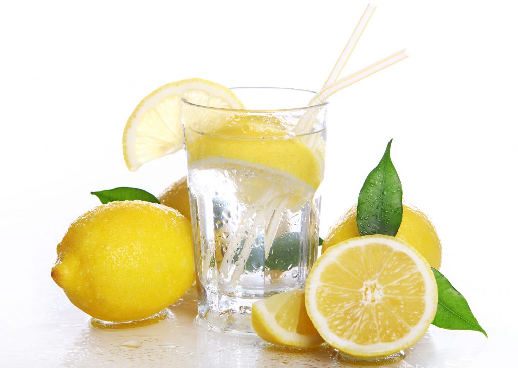 An appealing shot of a cocktail with fresh lemon, displayed against a white background.