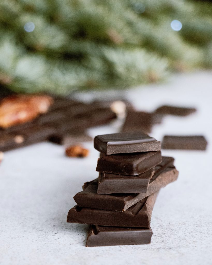 Close-up shot of dark chocolate pieces stacked vertically.