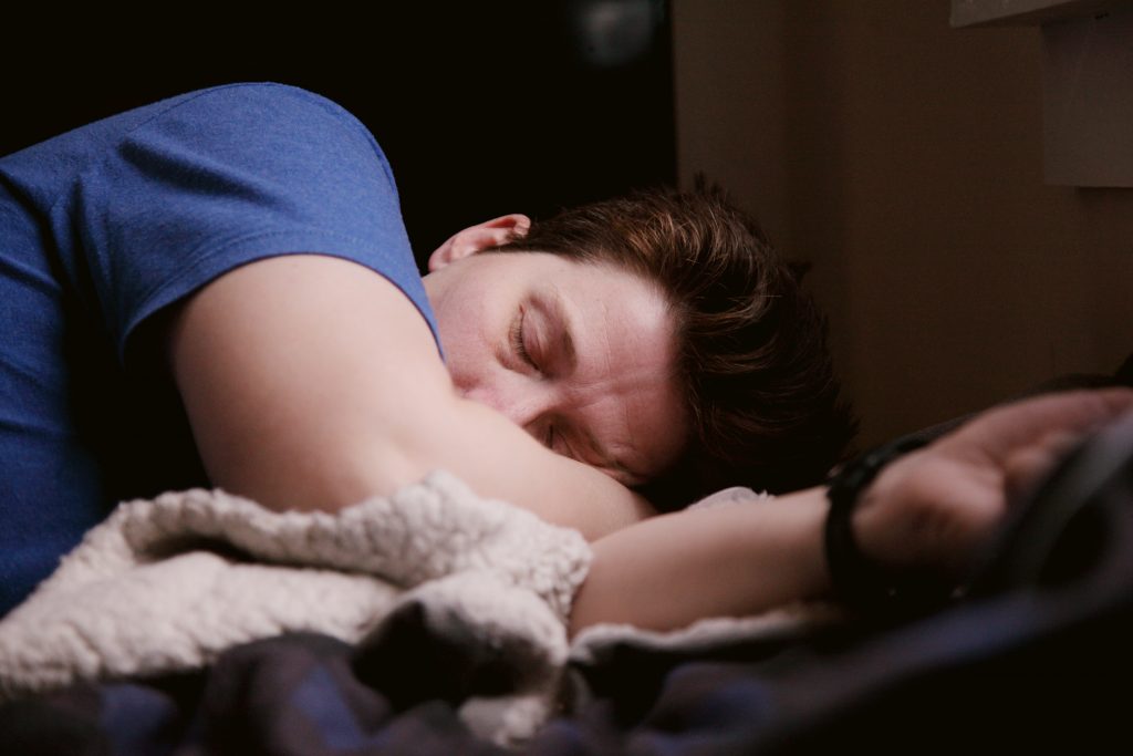 A fatigued man suffering from fibromyalgia, resting peacefully in a deep sleep