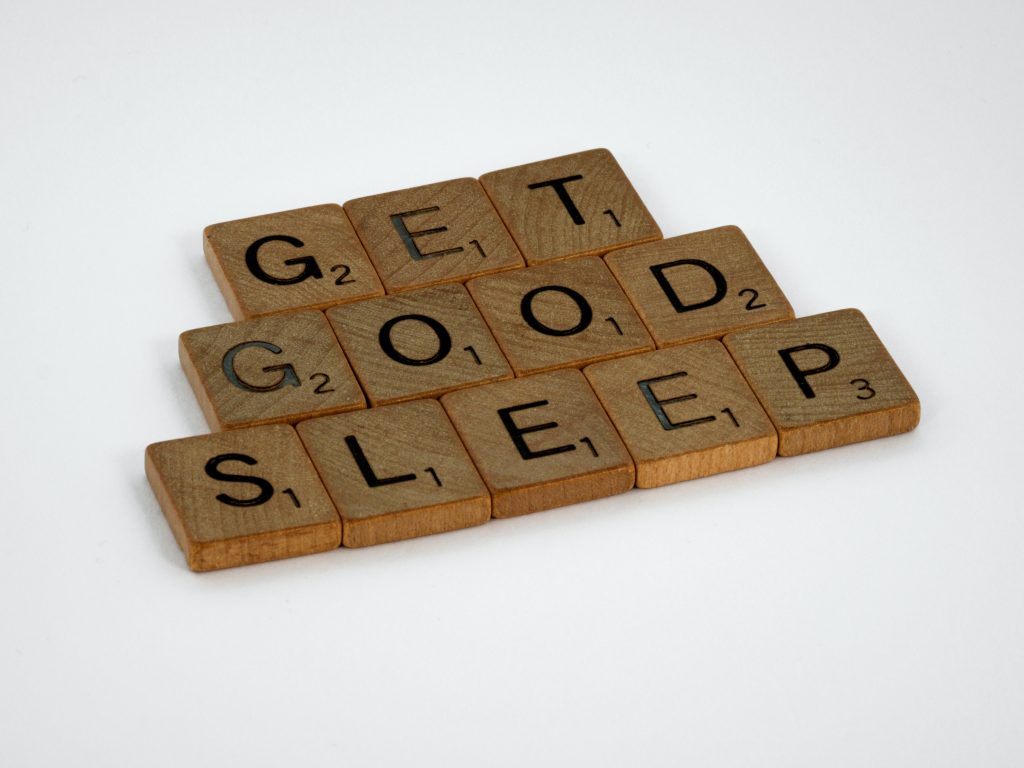 Scrabble tiles arranged to spell 'GET GOOD SLEEP'.