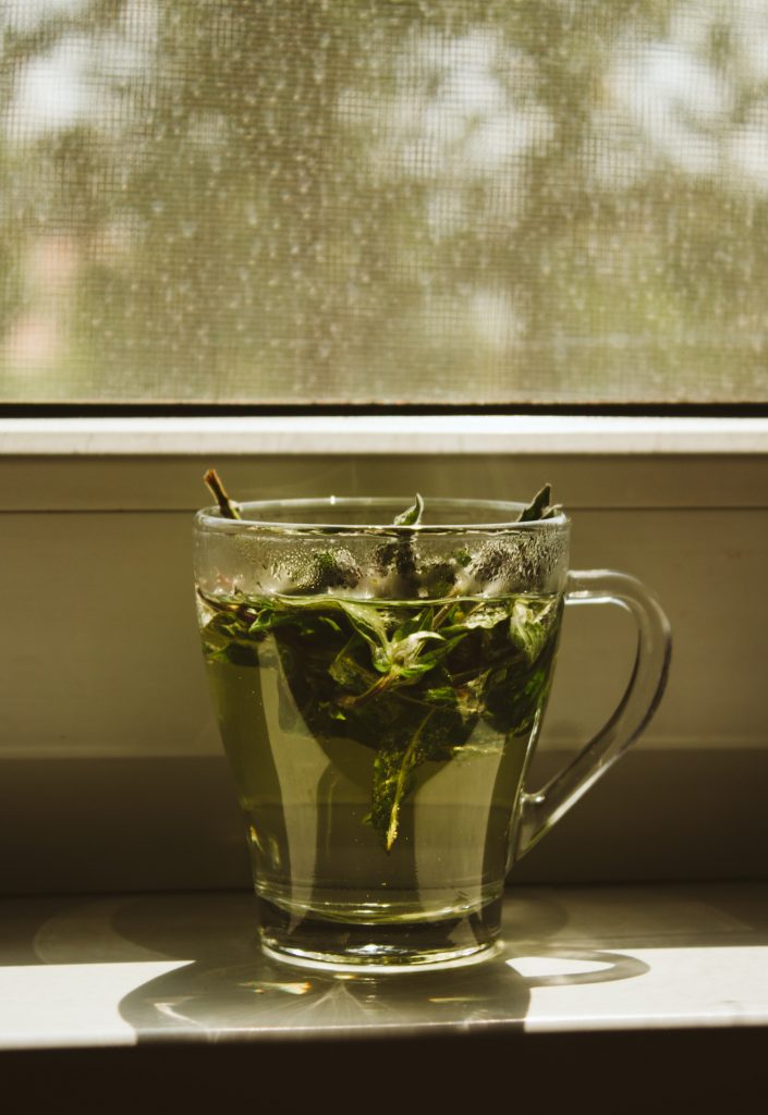 Aesthetic shot of black tea, known for its strong anti-inflammatory effects, served in a clear glass cup, showcasing its rich color and warmth