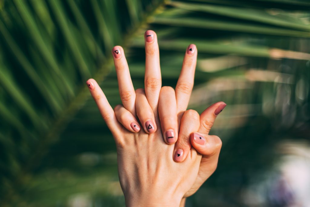 A close-up view of a woman performing a DIY hand massage for instant relaxation.