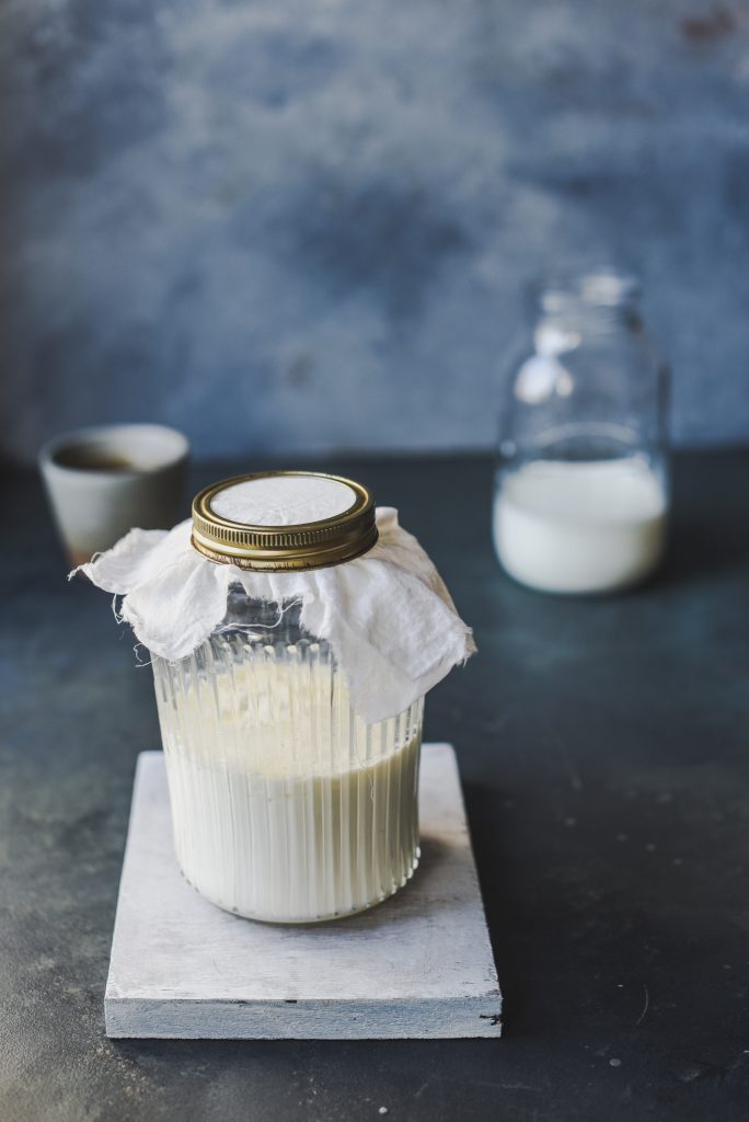 A visually appealing shot of kefir, a fermented yogurt-like beverage, neatly stored in a glass jar.