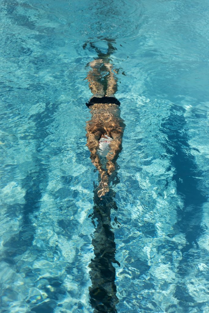 A man swimming in a pool.