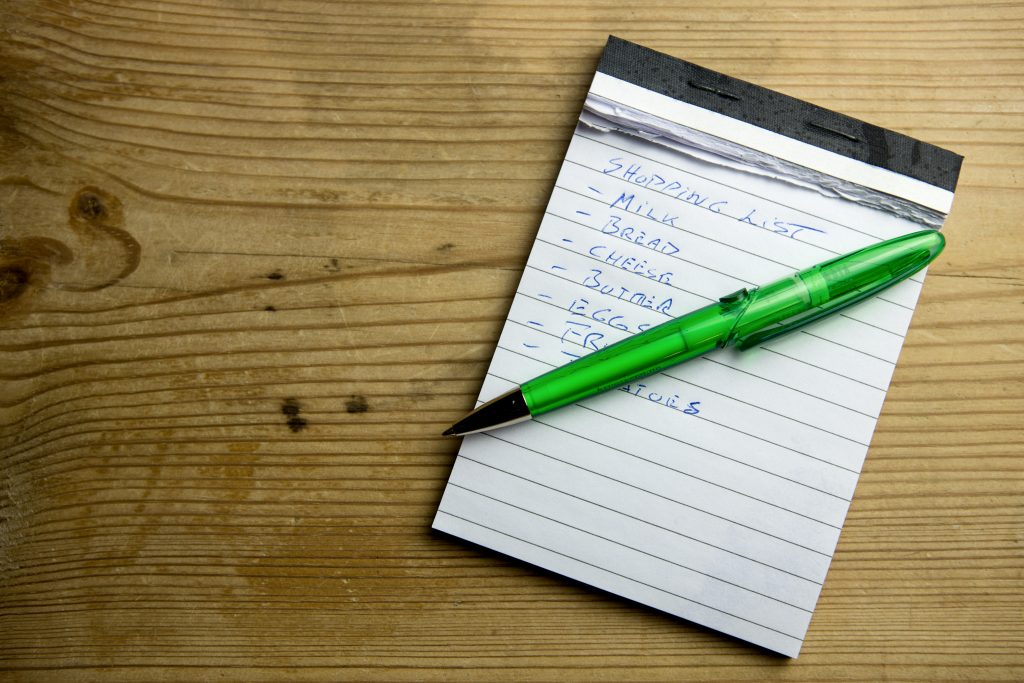 A candid shot of a notebook with a shopping list jotted down.