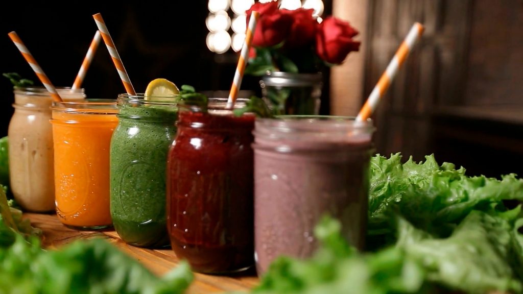 A candid shot of nutrient-packed smoothies in glass jars and neatly arranged in a row